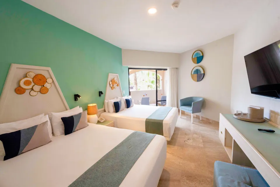 Two double beds in Superior Garden Room with balcony seating at Viva Maya