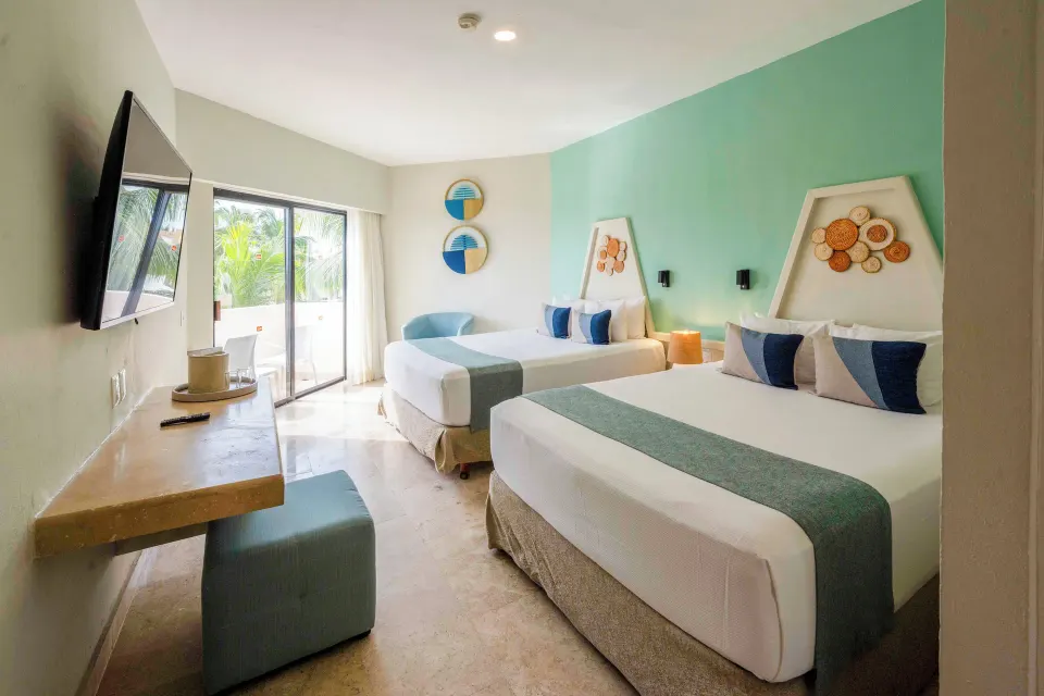 Interior view of Superior Garden Room with two queen beds and balcony at Viva Maya