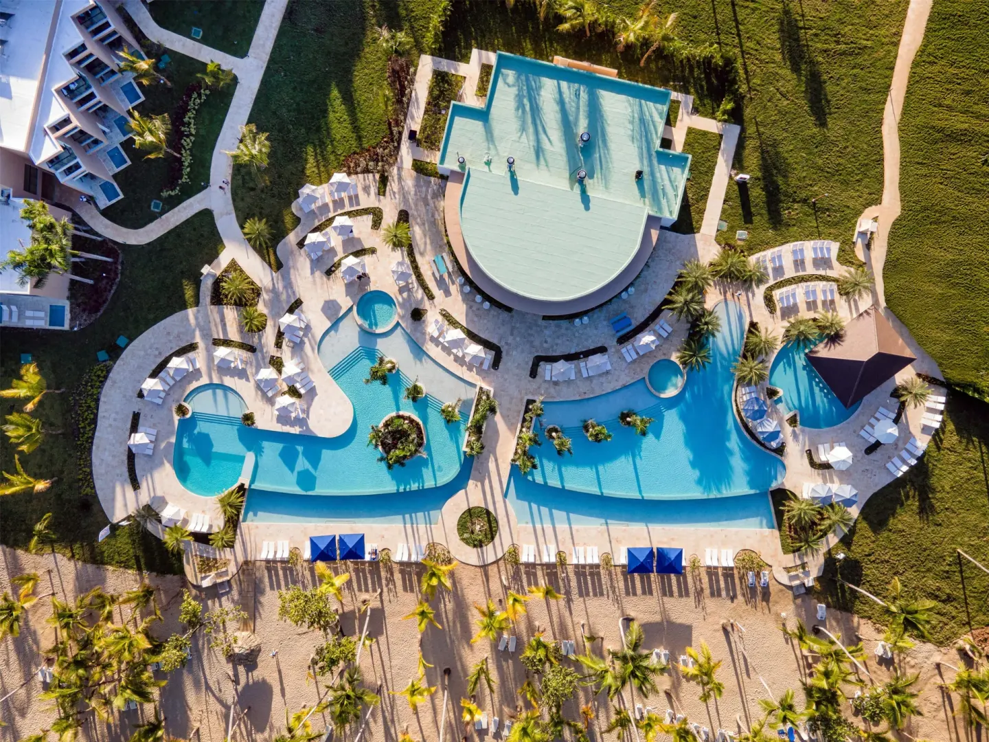 Overhead view of the pools, sundecks, palms, and resort buildings at Viva Miches.