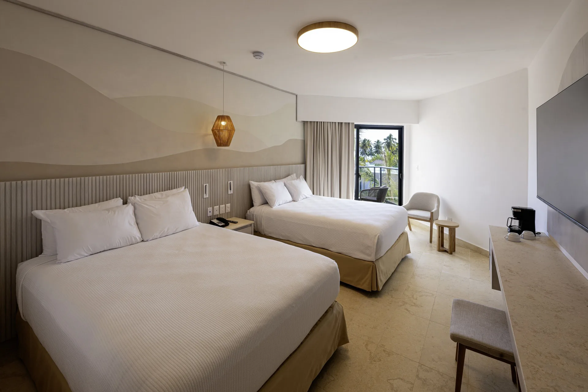 Two-bed guest room with balcony seating and a palm view at Viva Miches.