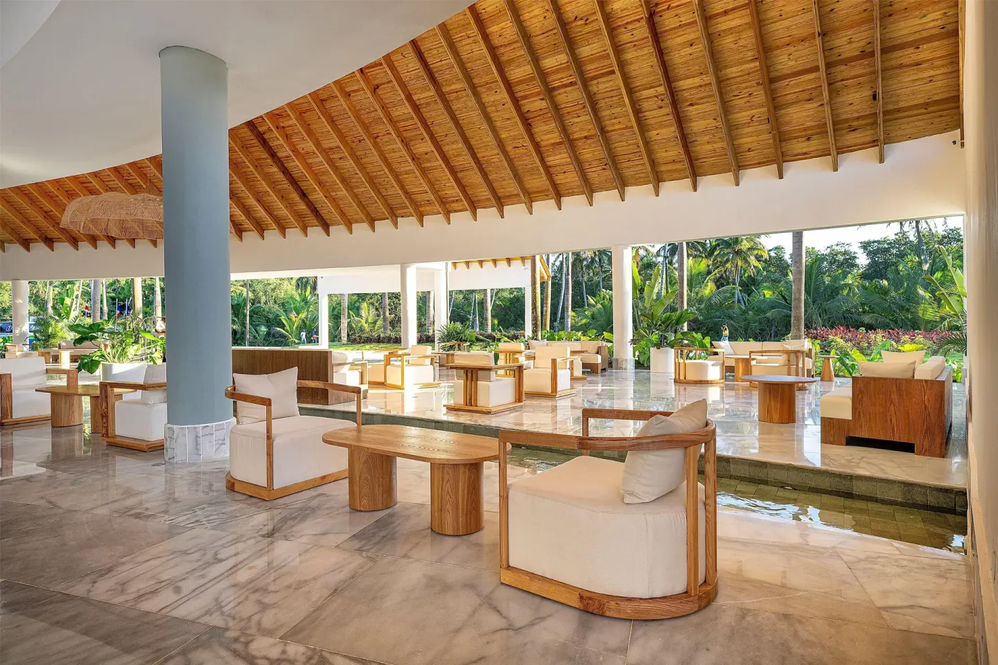 Open-air lobby lounge with wood ceiling and garden views at Viva Miches.