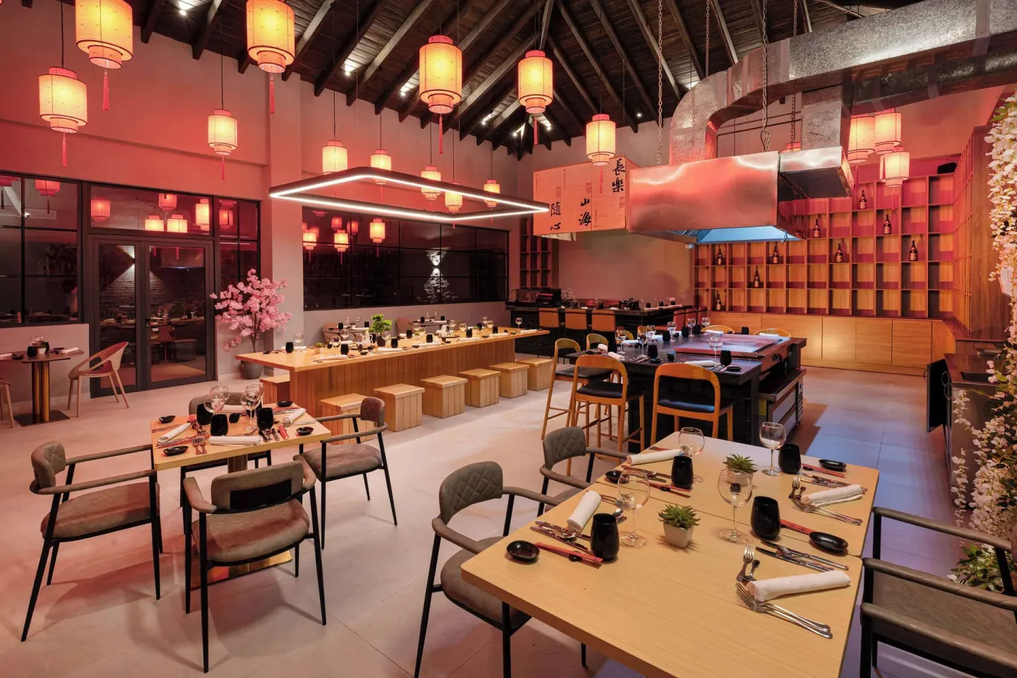 Lantern-lit dining room with set tables and counter seating at Viva Miches.