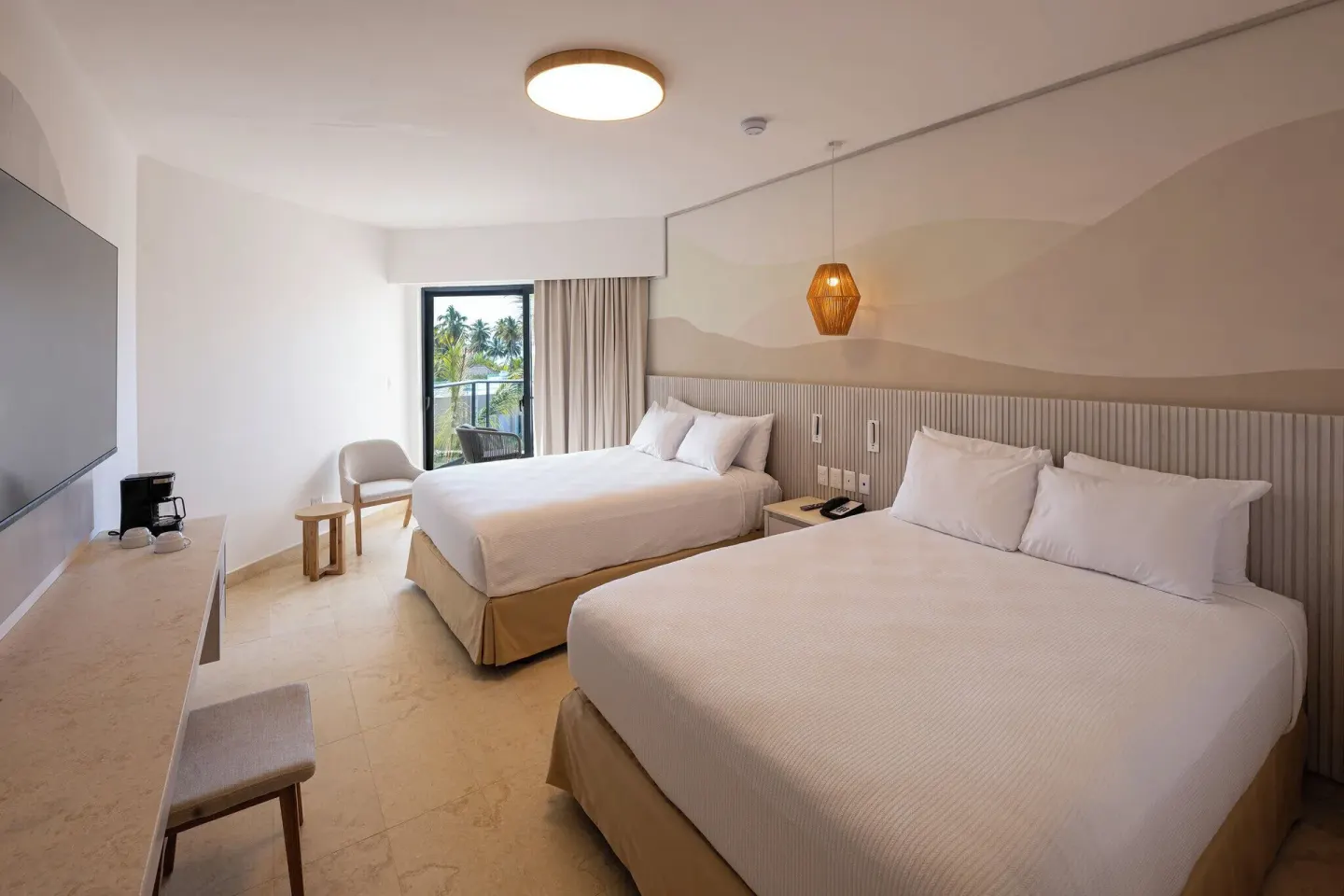 Splash Room with two queen beds, TV, and balcony doorway at Viva Miches.