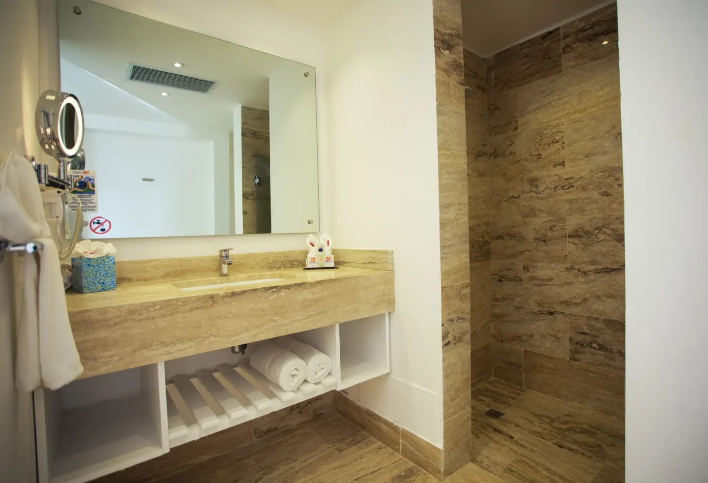 Oceanfront Suite bathroom vanity and walk-in shower at Viva Tangerine.