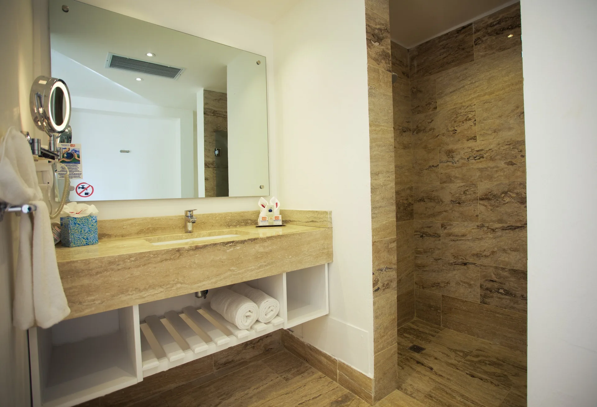 Oceanfront Suite bathroom vanity and walk-in shower at Viva Tangerine.