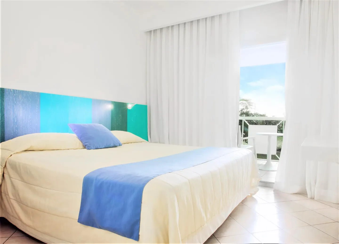 Superior Garden View Room with one bed and balcony doors at Viva Tangerine.