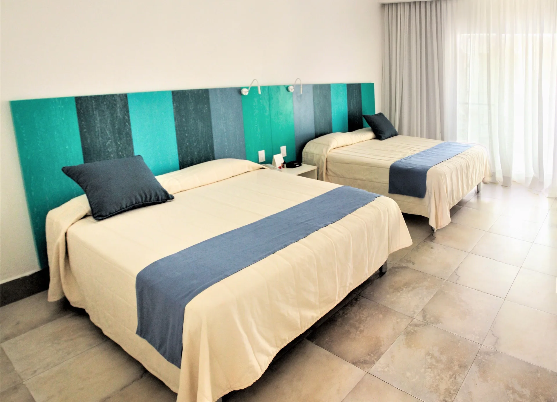 Superior Garden View Room with two beds and sheer curtains at Viva Tangerine.