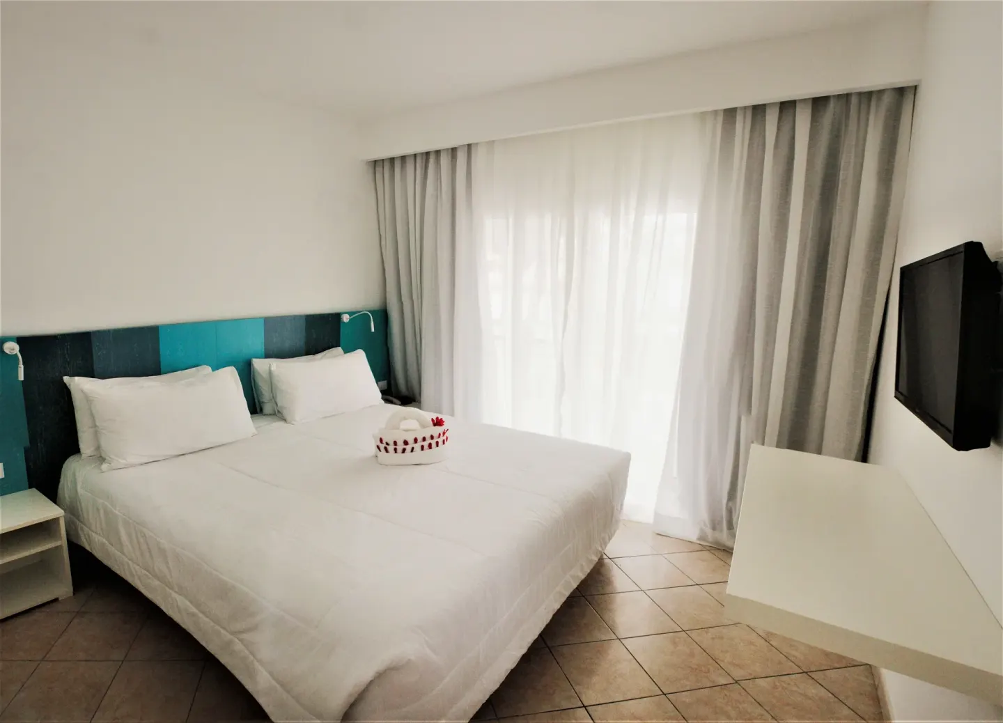 Superior Garden View Room with white bed and floating desk at Viva Tangerine.