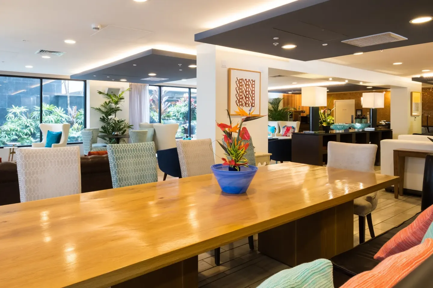 Communal lobby table with colorful seating at Vive Hotel Waikiki.