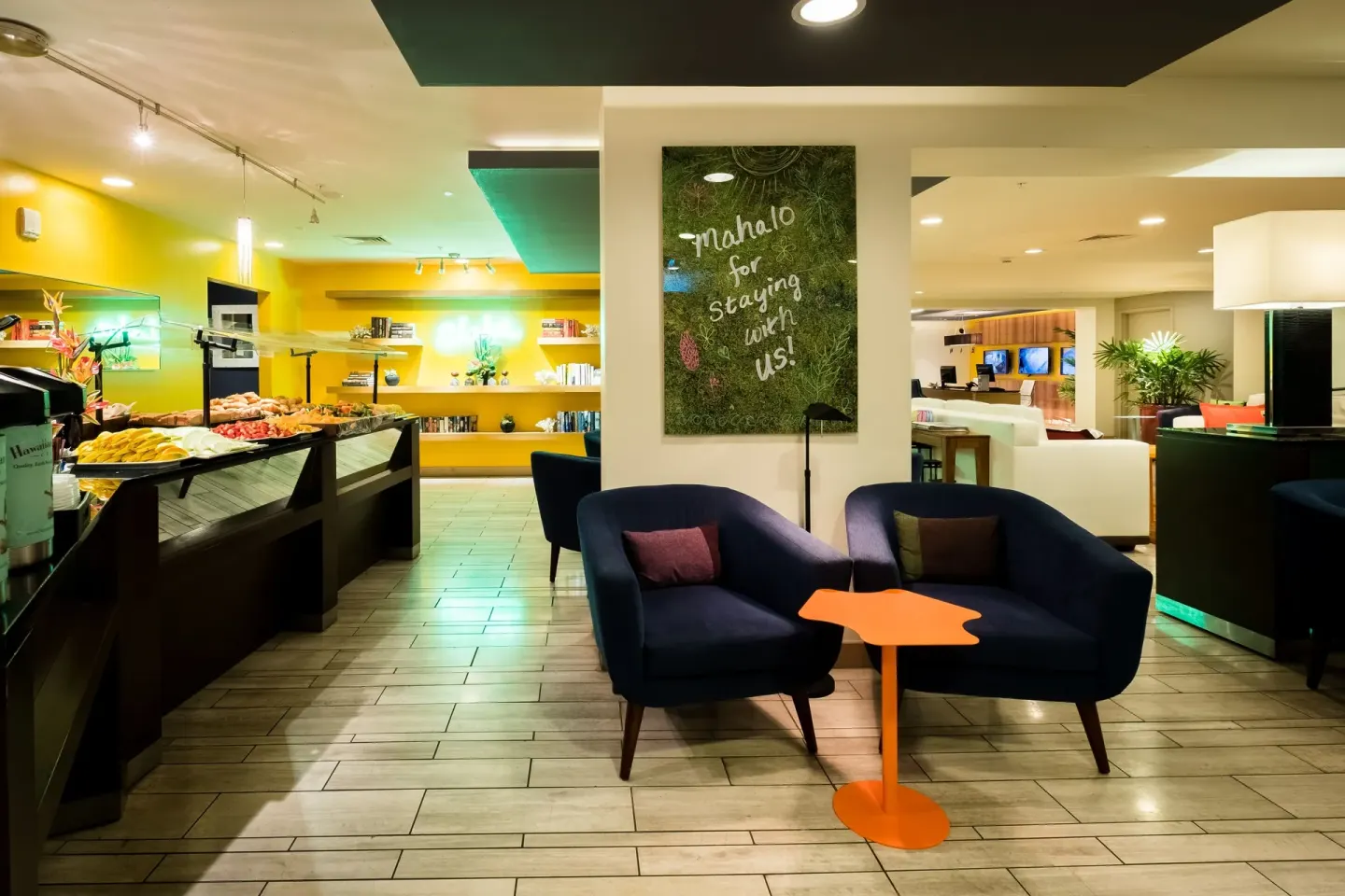 Colorful lobby lounge and breakfast display at Vive Hotel Waikiki.