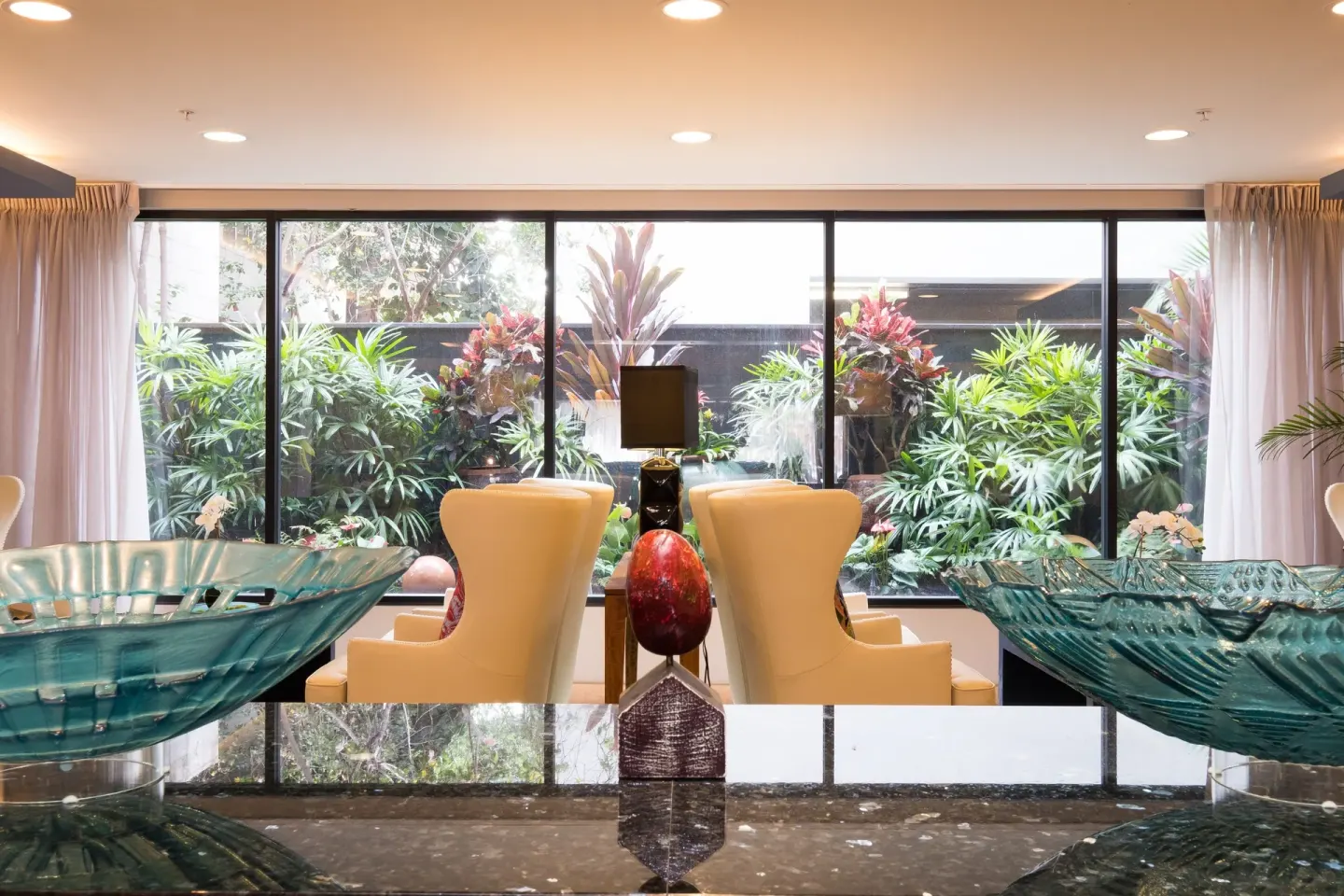 Lobby seating and tropical garden windows at Vive Hotel Waikiki.