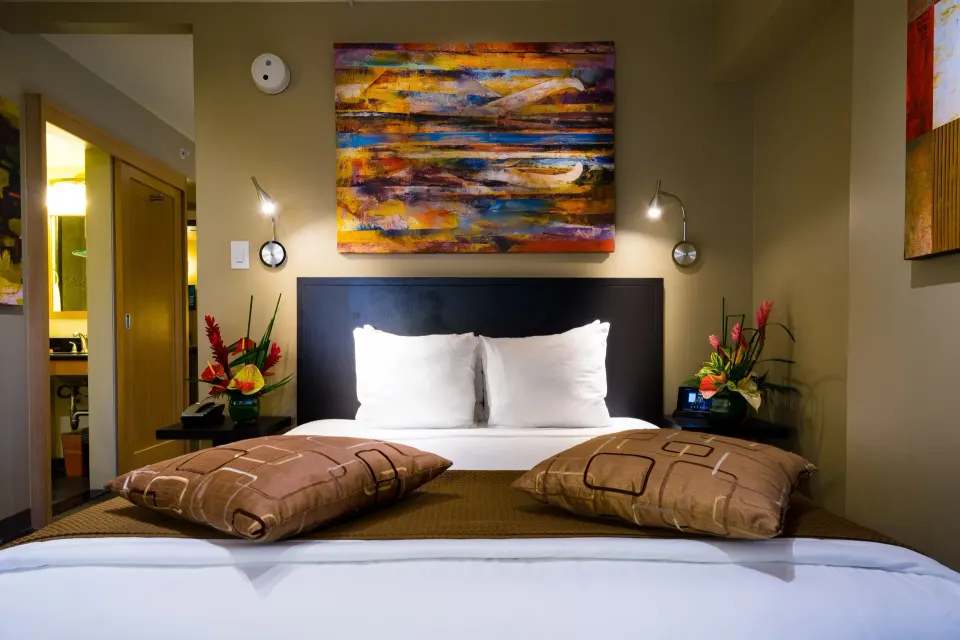 Close view of the bed in a Lifestyle Family Suite City View room at Vive Hotel Waikiki.