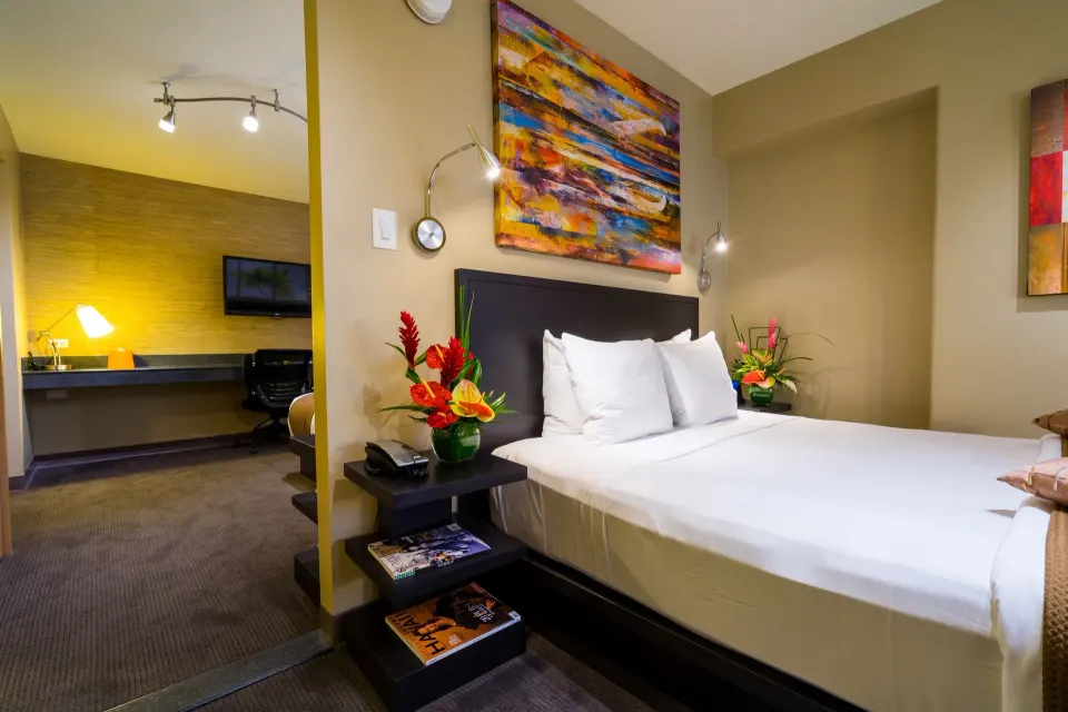 Side view of the bed in a Lifestyle Family Suite City View room at Vive Hotel Waikiki.