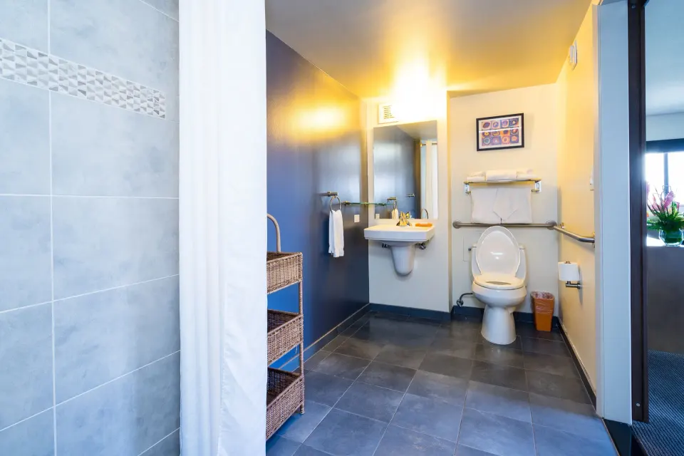 Accessible bathroom vanity and toilet in a Lifestyle Jr. Suite at Vive Hotel Waikiki.