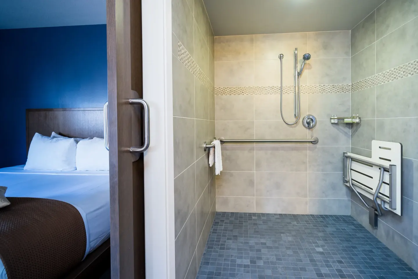 Accessible shower beside the bed in a Lifestyle Jr. Suite at Vive Hotel Waikiki.