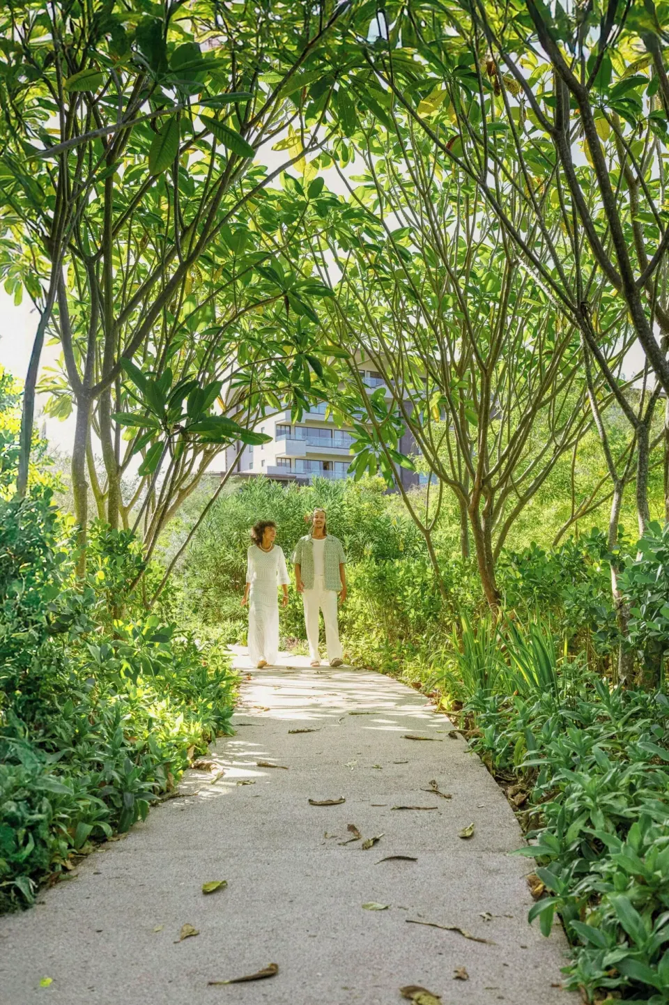 A garden walkway beneath leafy trees at W Costa Rica - Reserva Conchal.