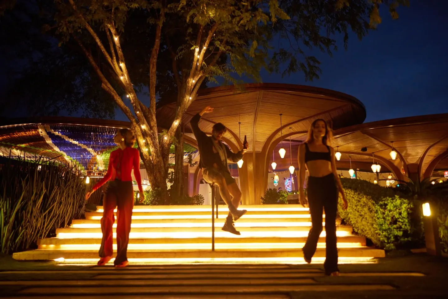 Guests walk down illuminated outdoor steps at night at W Costa Rica - Reserva Conchal.