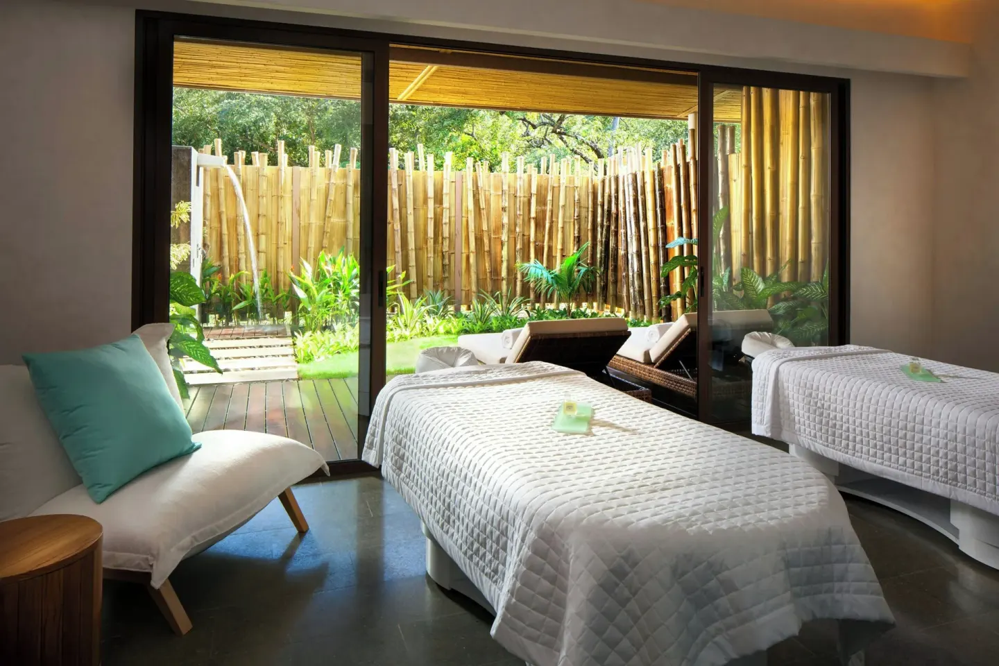 Spa treatment room with two beds and bamboo garden view at W Costa Rica - Reserva Conchal.