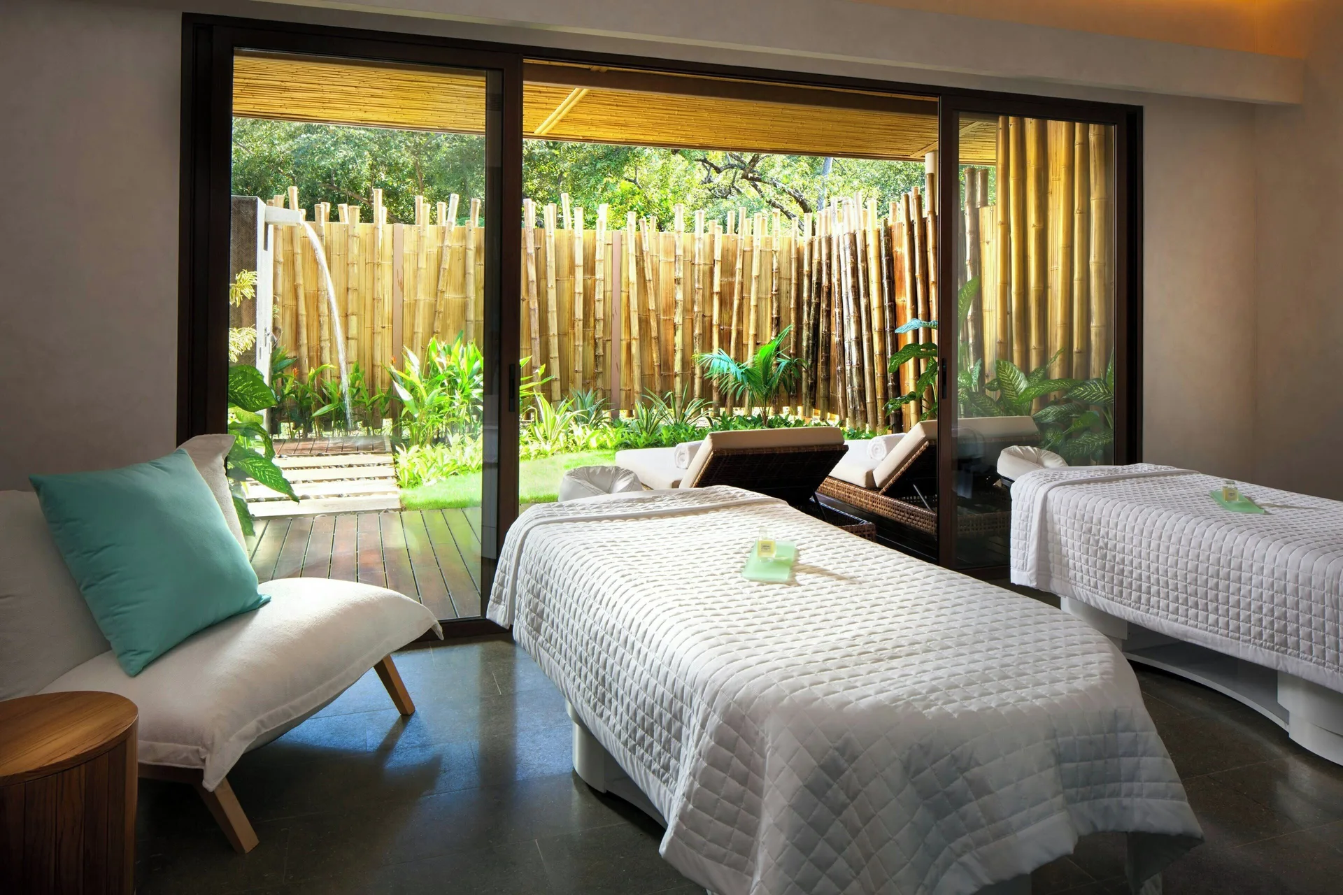 Spa treatment room with two beds and bamboo garden view at W Costa Rica - Reserva Conchal.