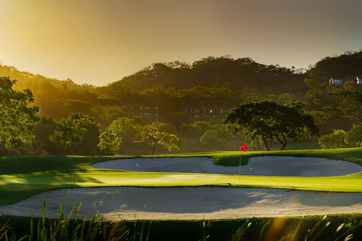 Golf green and sand bunkers at sunset at W Costa Rica - Reserva Conchal.