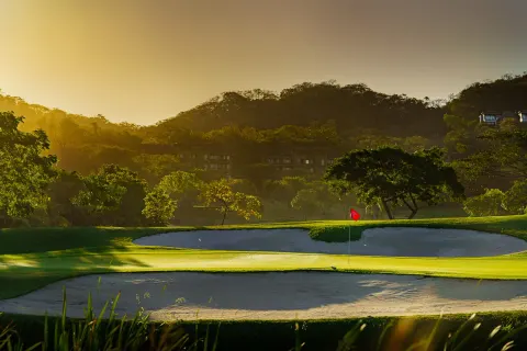 Golf green and sand bunkers at sunset at W Costa Rica - Reserva Conchal.