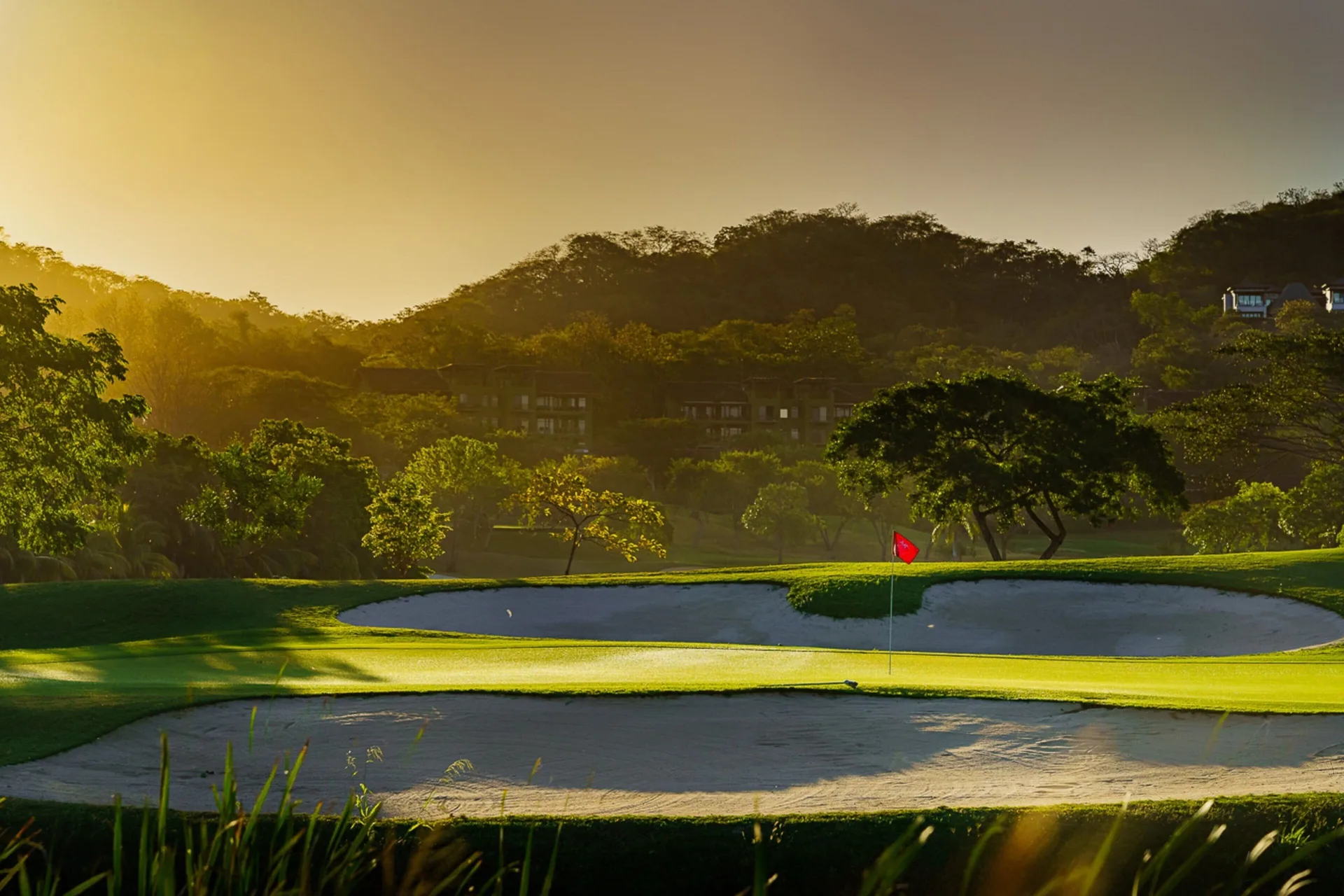 Golf green and sand bunkers at sunset at W Costa Rica - Reserva Conchal.