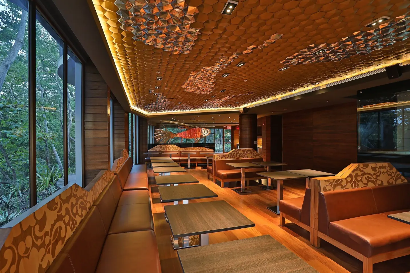 Lounge seating with forest views and a patterned ceiling at W Costa Rica - Reserva Conchal.