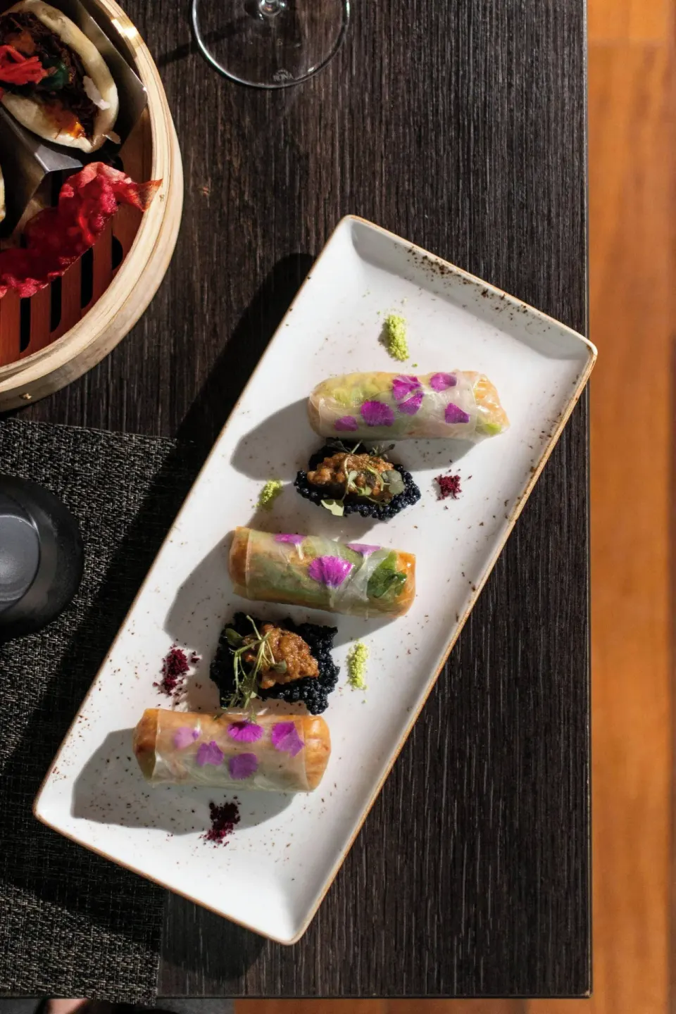 Plated rolls and small bites on a dining table at W Costa Rica - Reserva Conchal.