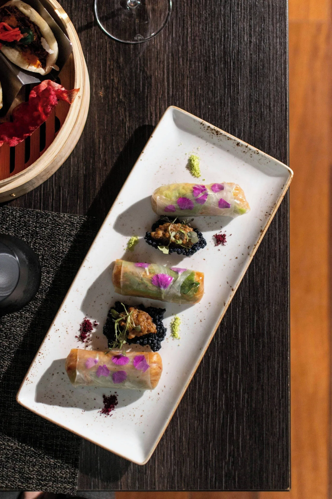 Plated rolls and small bites on a dining table at W Costa Rica - Reserva Conchal.