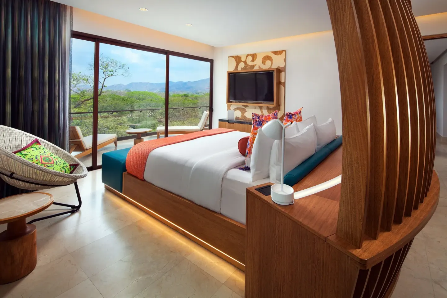 Deluxe Suite bedroom with king bed and balcony view at W Costa Rica - Reserva Conchal.