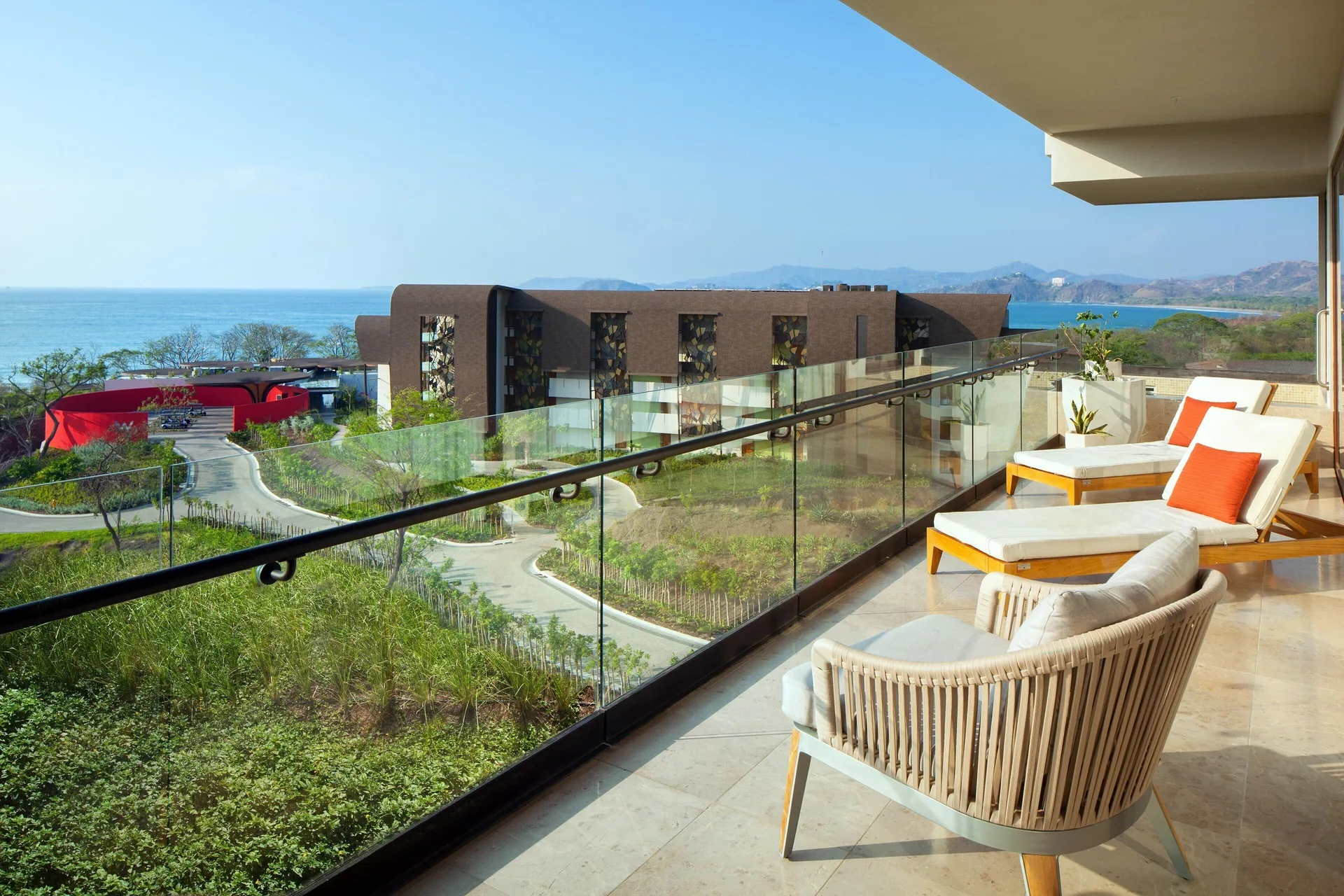 Premier Suite balcony with loungers and ocean view at W Costa Rica - Reserva Conchal.