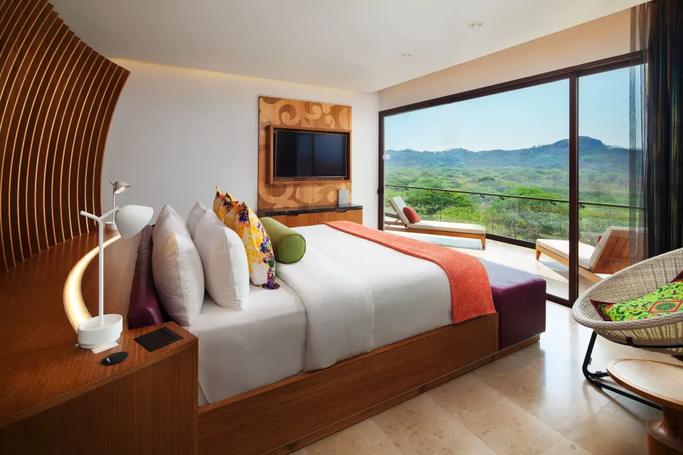 Premier Suite bedroom with king bed and balcony view at W Costa Rica - Reserva Conchal.