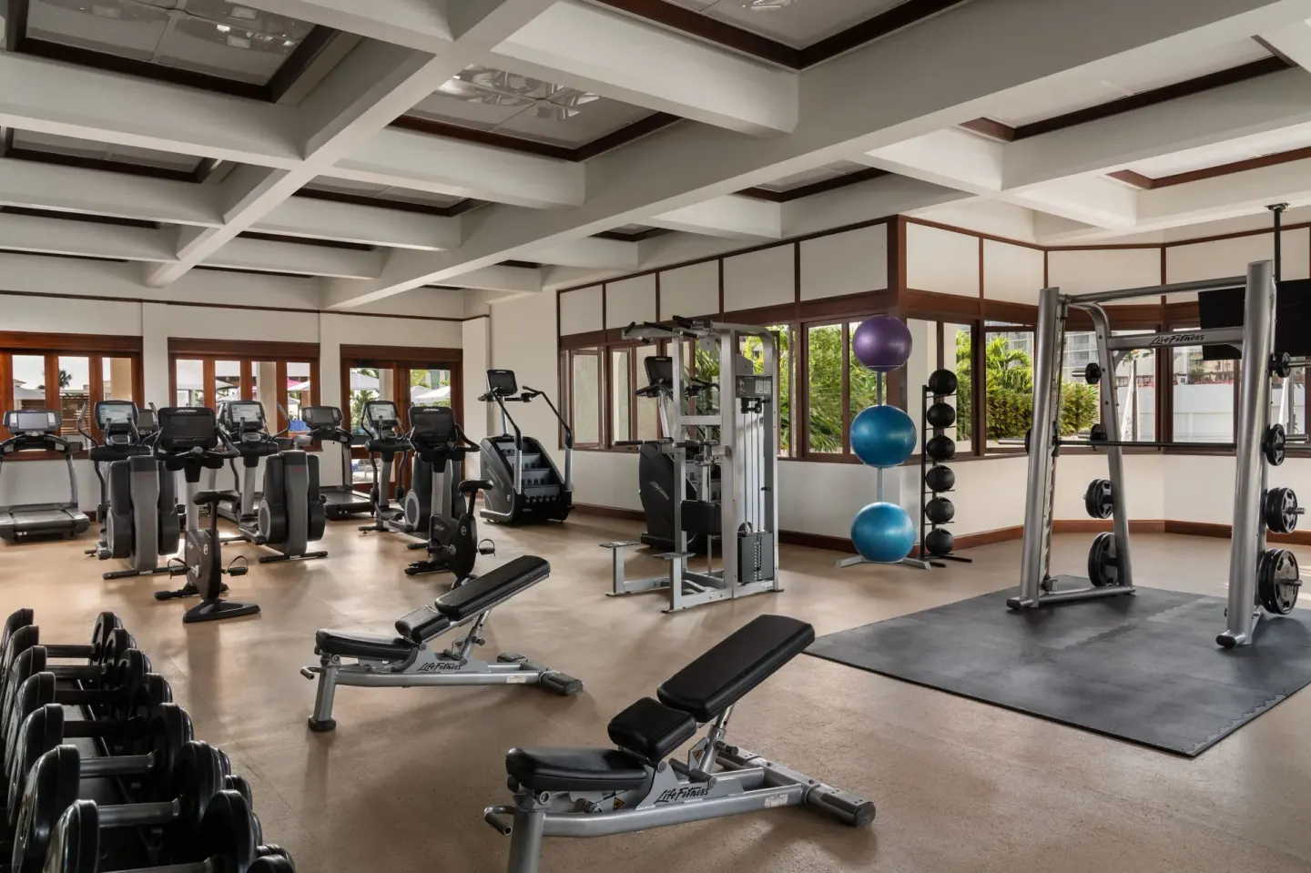 Fitness center with cardio machines and weights at Waikiki Beach Marriott Resort & Spa.
