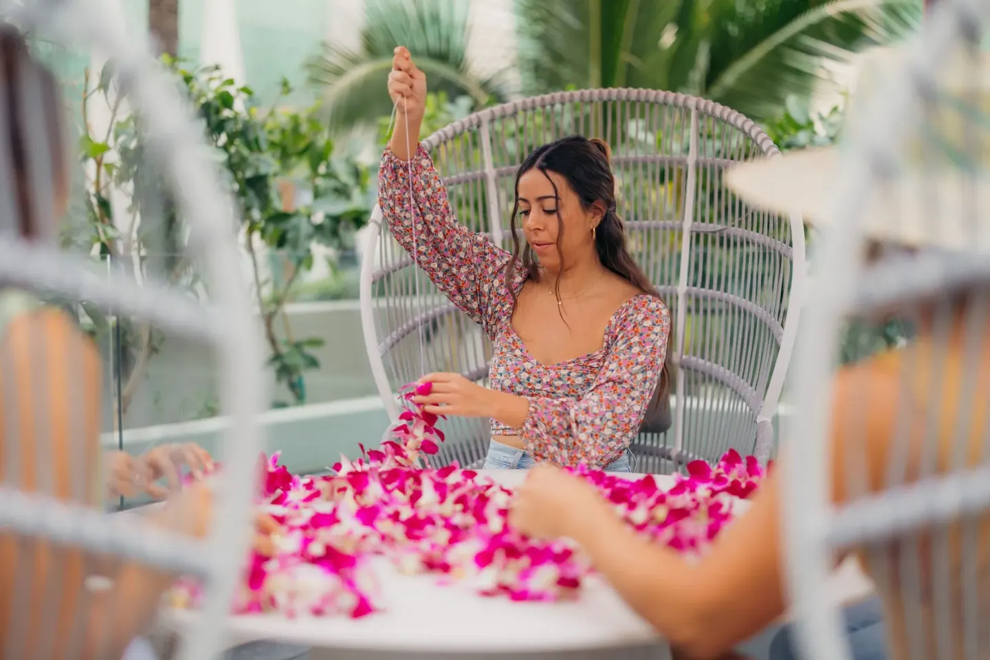 Guests string flower lei in a resort activity at Waikiki Beach Marriott Resort & Spa.