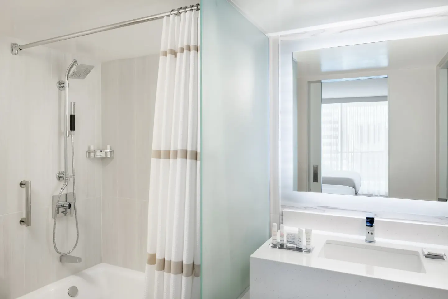 A bright bathroom with tub shower and vanity at Waikiki Beach Marriott Resort & Spa.
