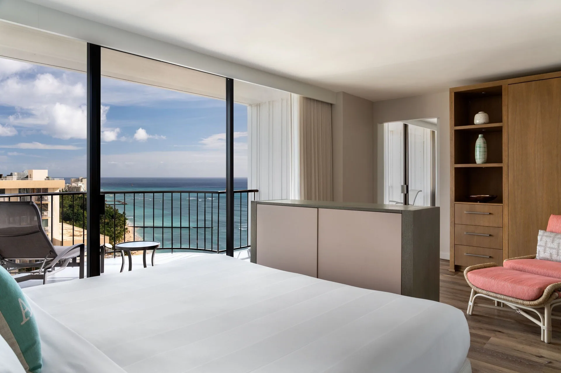 Ocean view guest room with balcony and chair at Waikiki Beach Marriott Resort & Spa.