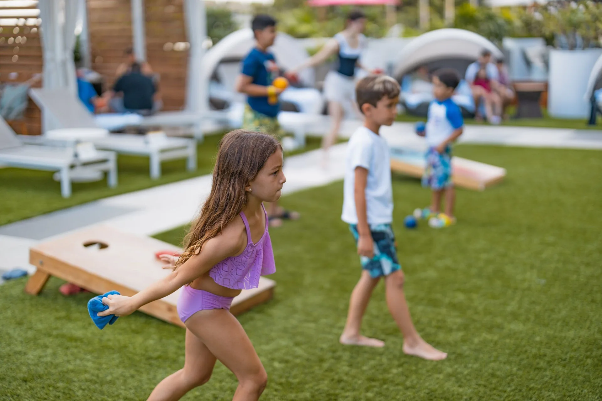 Children play lawn games on the resort deck at Waikiki Beach Marriott Resort & Spa.