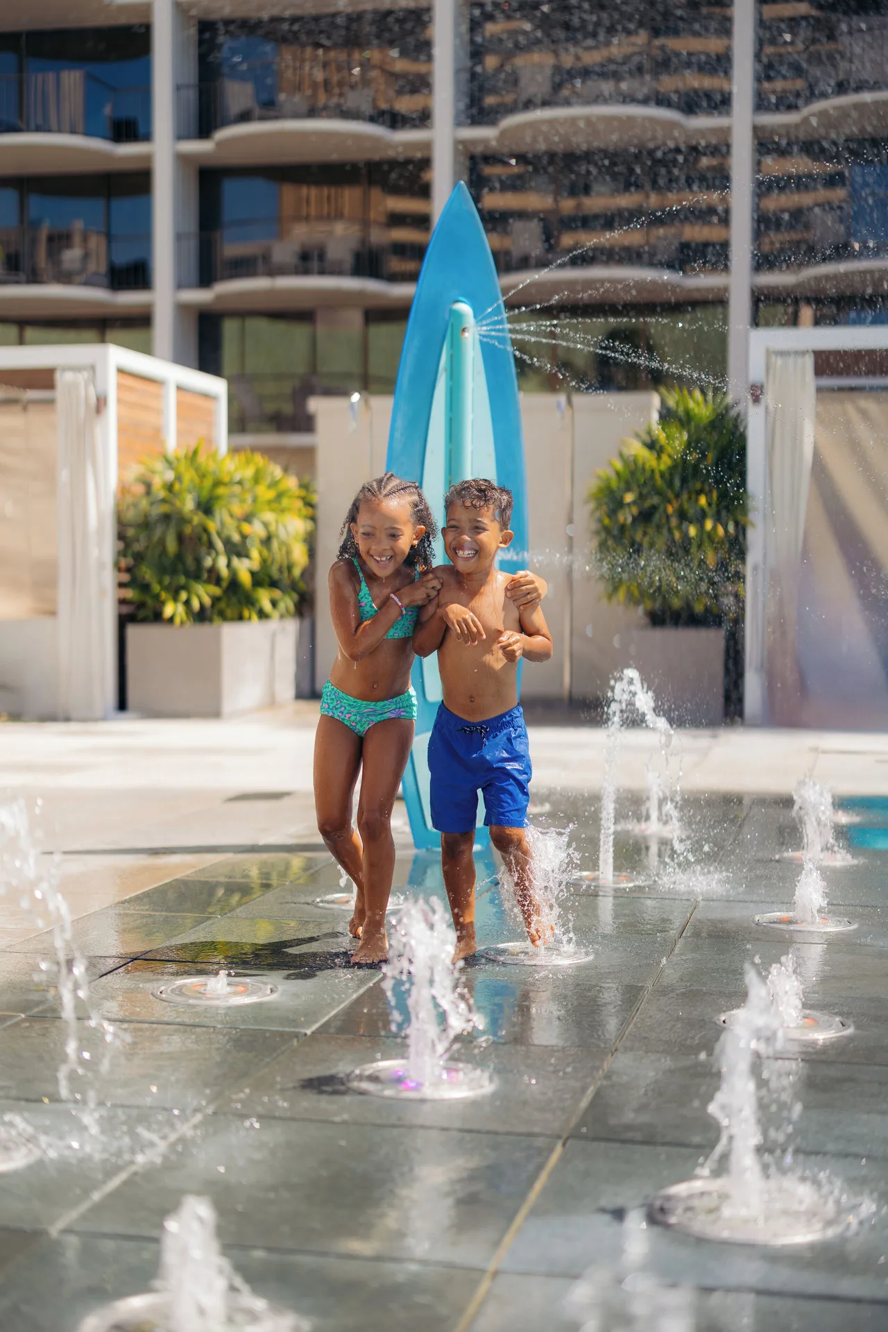 Children run through splash pad fountains at Waikiki Beach Marriott Resort & Spa.