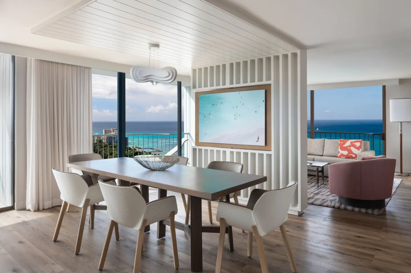 An ocean-view dining and living area in a suite at Waikiki Beach Marriott Resort & Spa.
