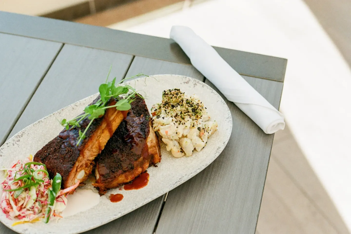 Barbecue ribs with sides on a table at Waikiki Beach Marriott Resort & Spa.