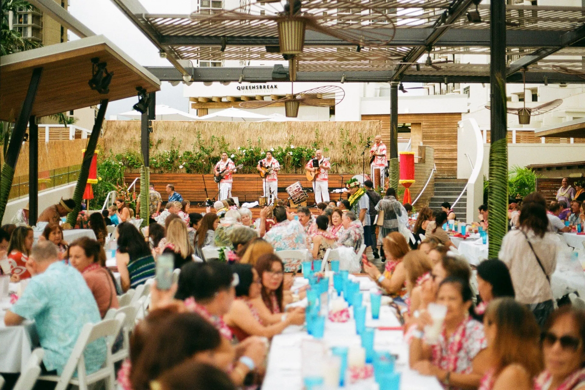 Guests watch live music during a luau at Waikiki Beach Marriott Resort & Spa.