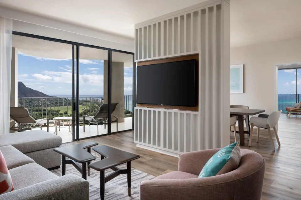 Deluxe One-Bedroom Suite living area and balcony at Waikiki Beach Marriott Resort & Spa.