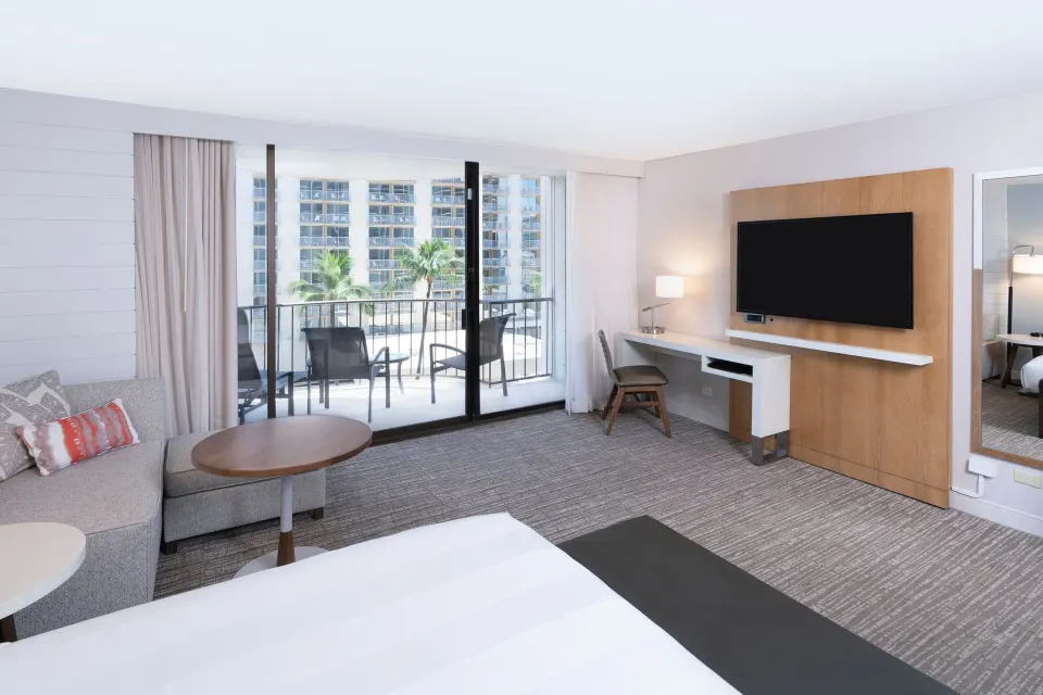Waikiki Beach Marriott Resort & Spa king room with sofa bed and courtyard-facing balcony at Waikiki Beach Marriott Resort & Spa