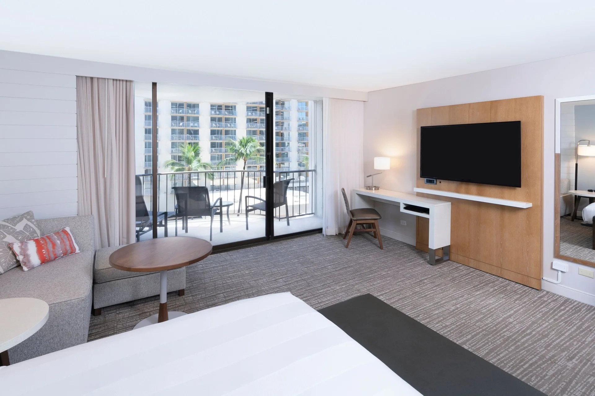Waikiki Beach Marriott Resort & Spa king room with sofa bed and courtyard-facing balcony at Waikiki Beach Marriott Resort & Spa
