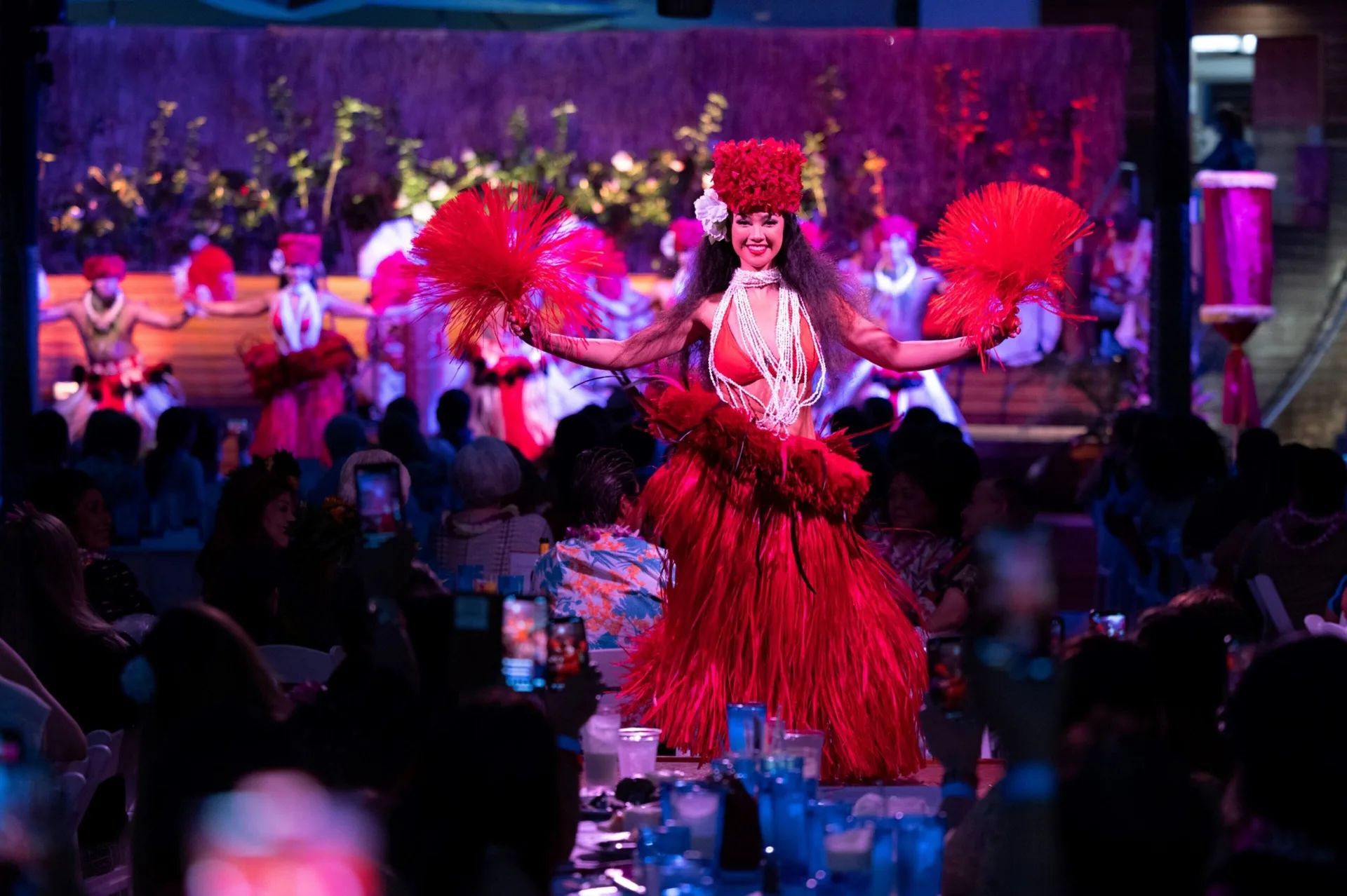 Hula dancer performs in red costume at Waikiki Beach Marriott Resort & Spa.
