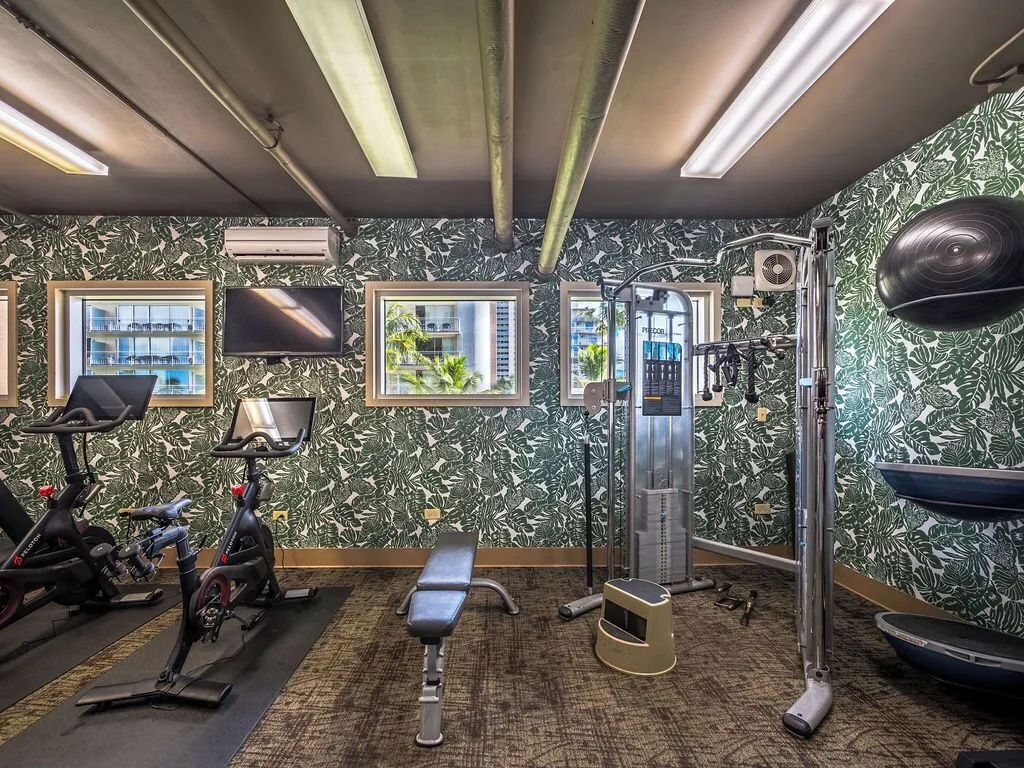Fitness room with bikes, bench, cable machine, and balance gear at Waikiki Malia.