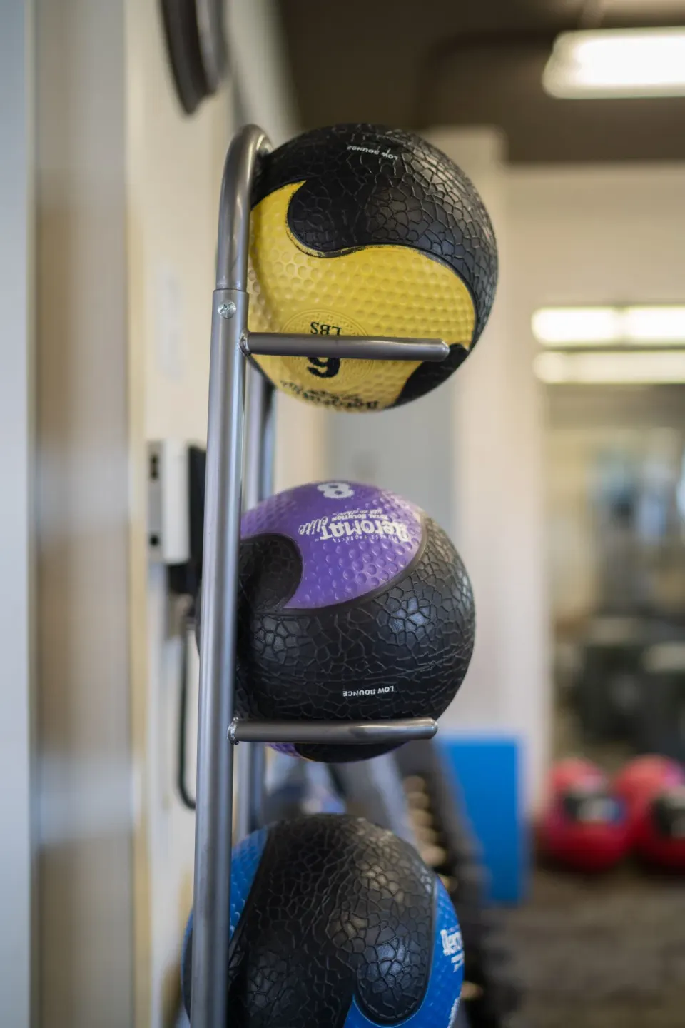 Close-up of medicine balls on a rack in the fitness room at Waikiki Malia.