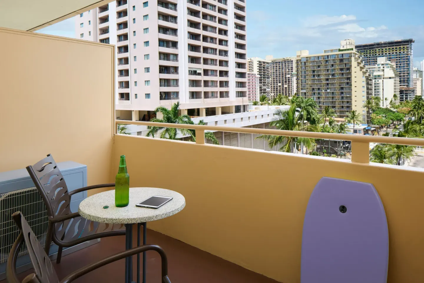 Balcony with table, chairs, and city views at Waikiki Malia.