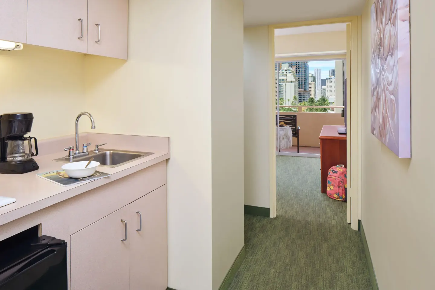 Guest room kitchenette hallway leading to a balcony at Waikiki Malia.