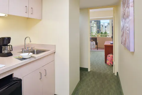 Guest room kitchenette hallway leading to a balcony at Waikiki Malia.
